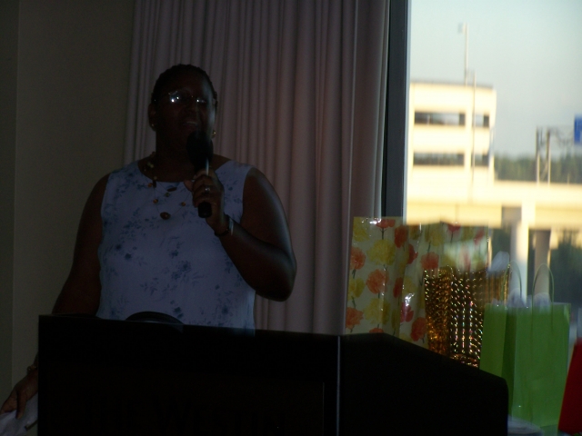 Renee Bowles serves as auctioneer at first Grier Family Reunion scholarship fundraiser.